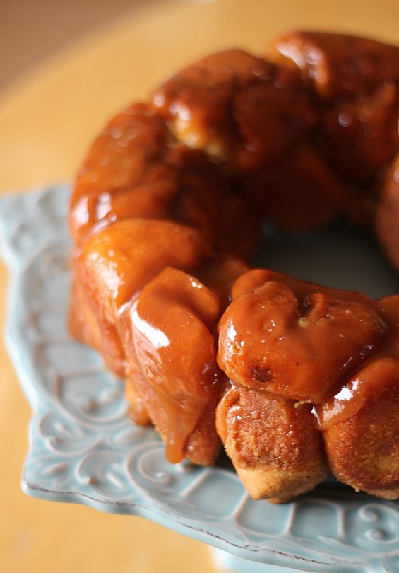 Monkey Bread inverted onto a serving plate, coated in melted butter and brown sugar