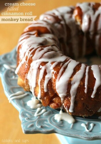 Title image of Cinnamon Roll Monkey Bread with Cream Cheese Filling drizzled with vanilla icing.