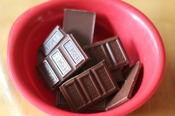 Pieces of Hershey's chocolate bar in a red bowl