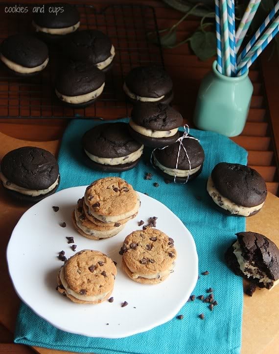 Chocolate chip whoopie pies on a plate surrounded by chocolate whoopie pies with cookie dough filling