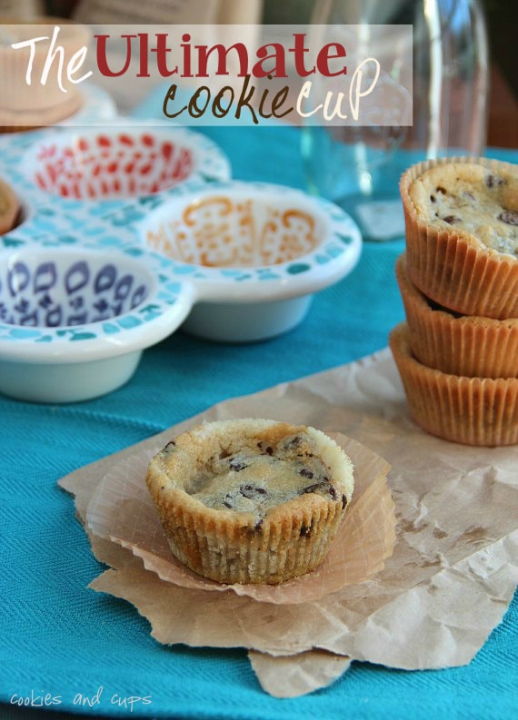 Ultimate cookie cup with chocolate chips on a napkin with other cookie cups stacked behind it