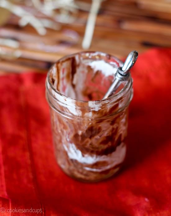 An empty jar of S'mores parfait with a spoon