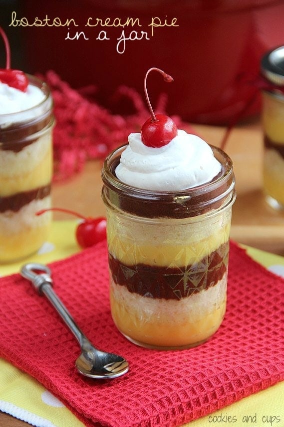 Image of boston cream pie in a jar with a cherry on top