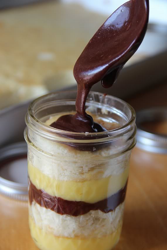 Boston Cream Pie in a Jar made up of layers of vanilla pudding, vanilla cake and chocolate sauce