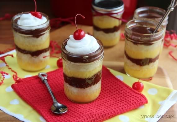 Four jars of Boston Cream Pie in a Jar topped with whipped cream and a cherry