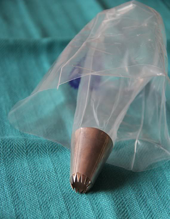 Empty clear plastic piping bag with a star tip