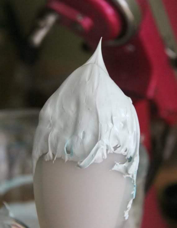 Egg whites with a stiff peak on a spatula