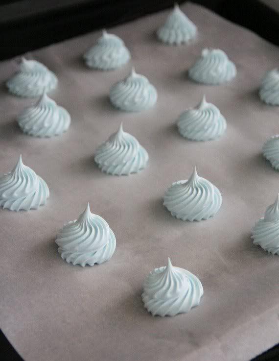 Swirls of blue meringue batter on a baking sheet