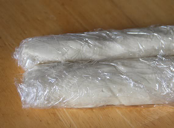 Two logs of key lime shortbread cookie dough wrapped in plastic