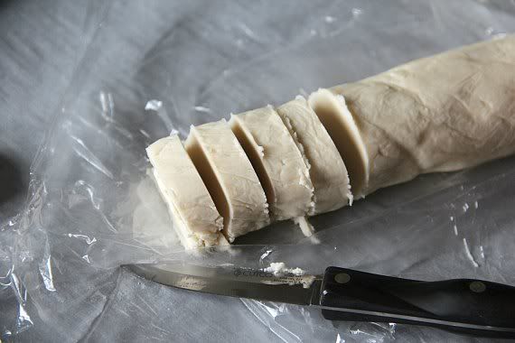 A partially sliced log of key lime shortbread cookie dough