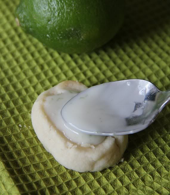 Lime glaze being spread onto a shortbread cookie