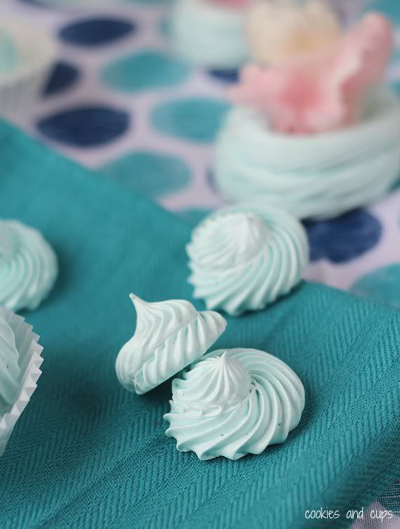 Baked cotton candy meringues on a blue cloth