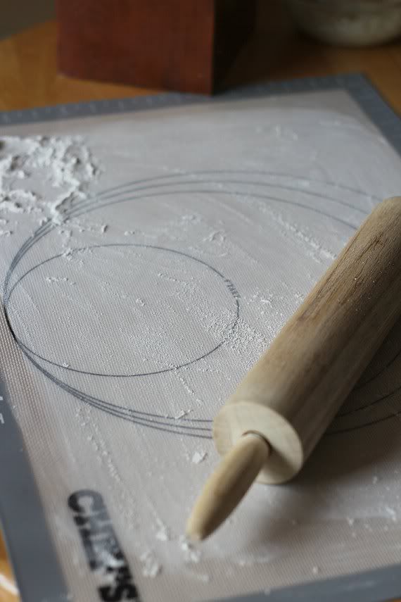 A baking mat with circles and a rolling pin