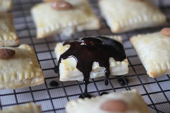 Pastry square covered in melted chocolate on a cooling rack