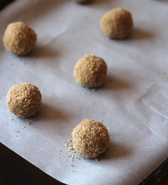 Cookie dough balls on a parchment-lined baking sheet