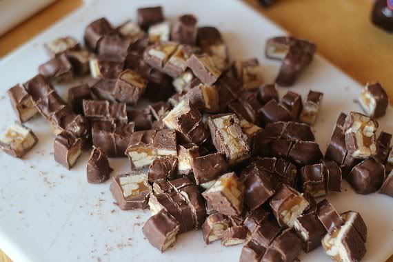 Chopped Snickers candy on parchment paper