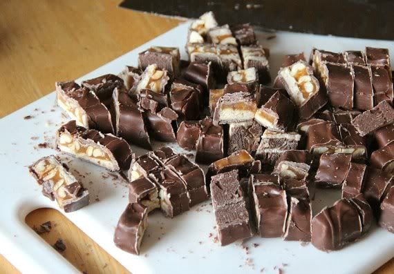 Chopped Snickers bars on a cutting board