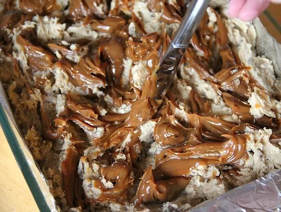 Caramel being swirled into batter in a baking pan