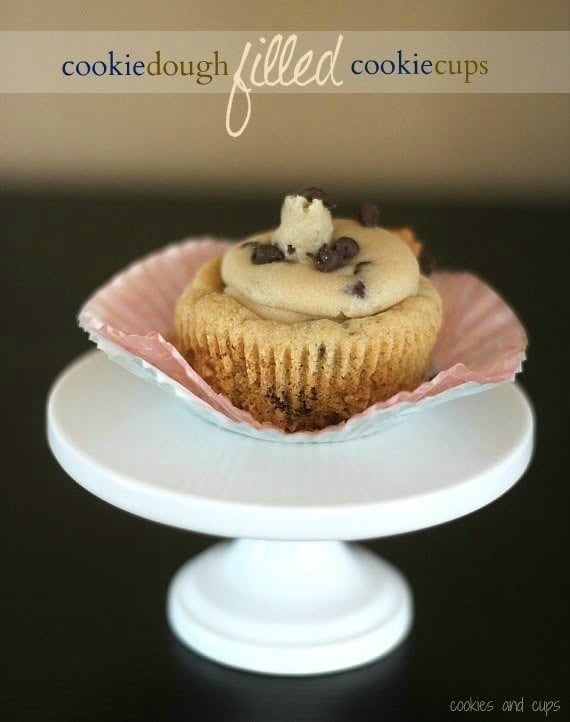 A Cookie Dough Filled Cookie Cup on a mini white cake stand