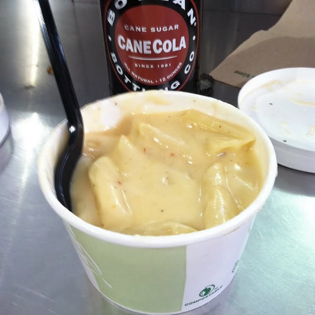Creamy macaroni and cheese in a disposable bowl