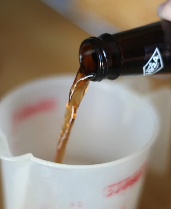 Root beer being poured into a liquid measuring cup