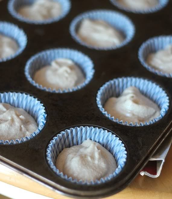 Vanilla cupcake batter in a paper-lined muffin tin