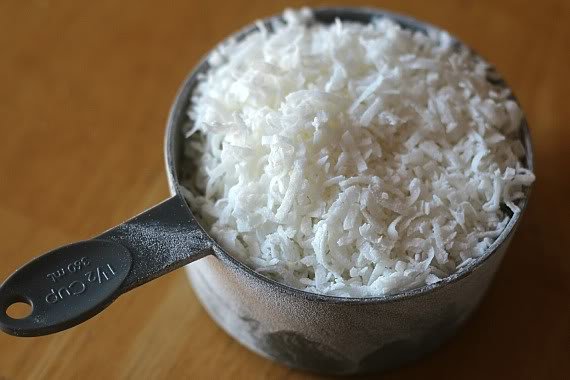 A measuring cup of shredded coconut