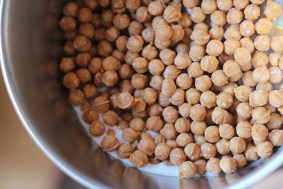 Top view of round caramel bits with milk in a saucepan