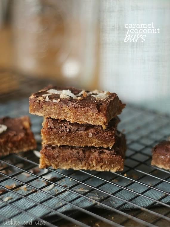 Three Caramel Coconut Bars stacked on a cooling rack