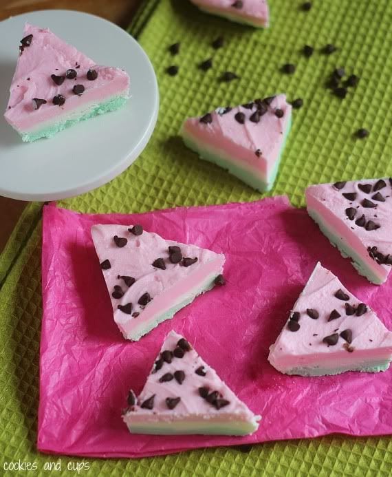Triangles of pink and green layered watermelon fudge topped with mini chocolate chips