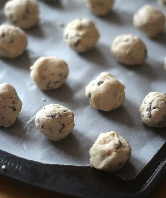 Cookie dough balls on a parchment-lined baking sheet