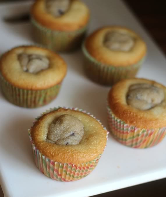 Vanilla cupcakes with a cookie dough ball in the middle of each