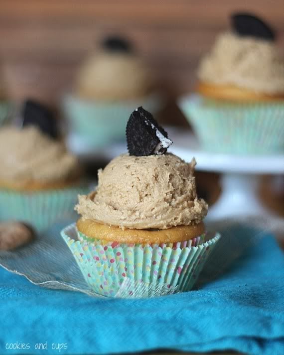 Cupcake with a scoop of frosting and a quarter of an oreo cookie on top