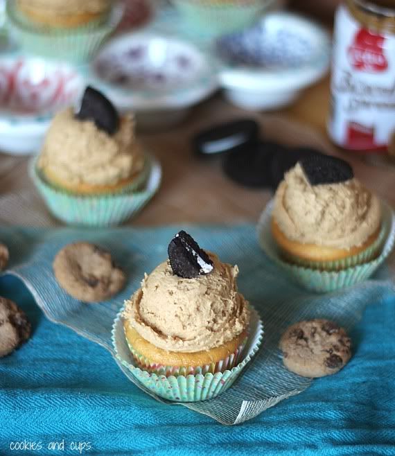 Cupcakes with peanut butter frosting and a quarter of an Oreo cookie on top