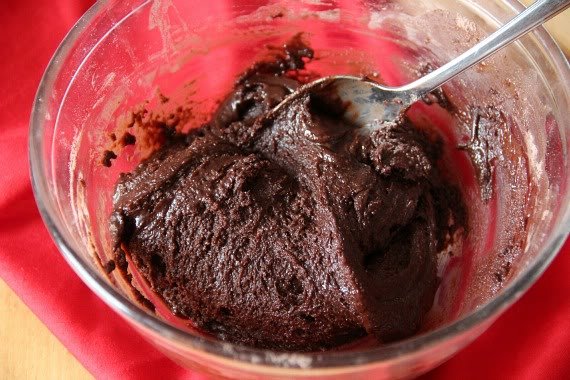 Brownie batter in a mixing bowl with a spoon
