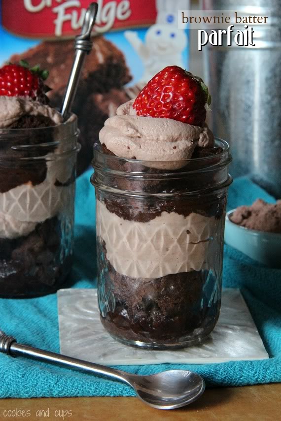 A brownie batter parfait in a jar with a strawberry on top