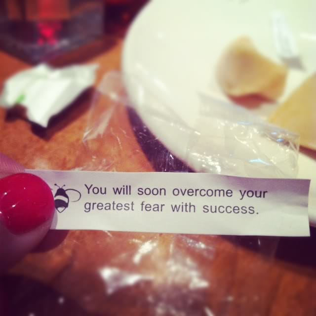 A fortune cookie paper with the words "You will soon overcome your greatest fear with success."