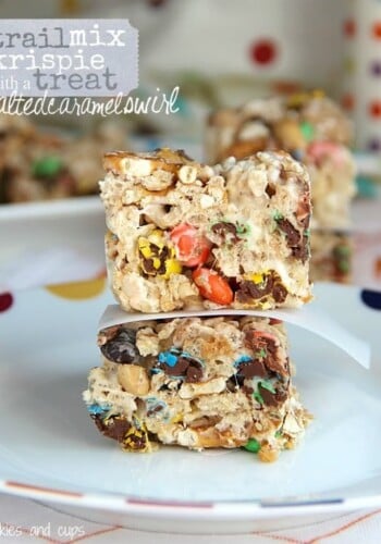 Two trail mix krispie treats stacked on a plate