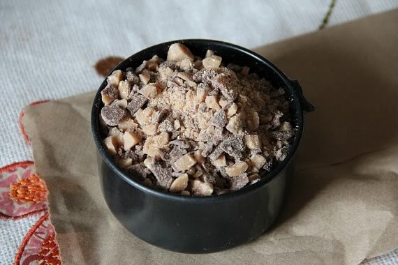 A black cup of crushed toffee pieces