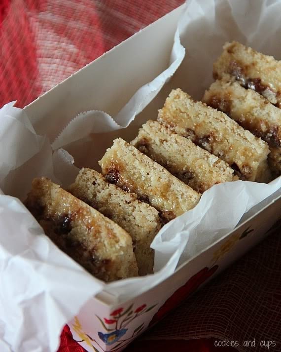 A stack of cake mix toffee bars in a parchment-lined box