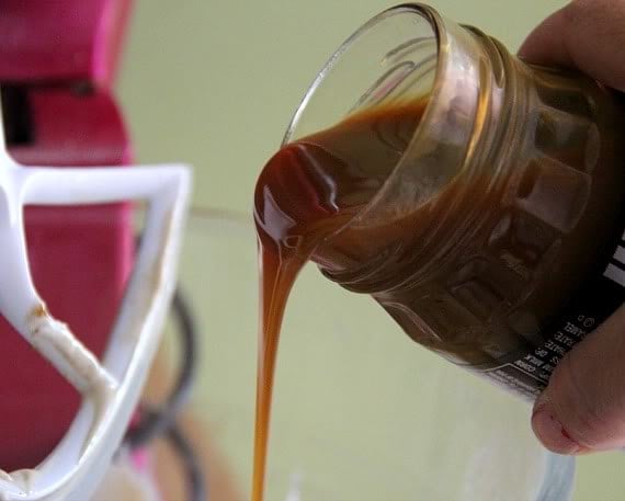 Caramel sauce being poured out of a jar 
