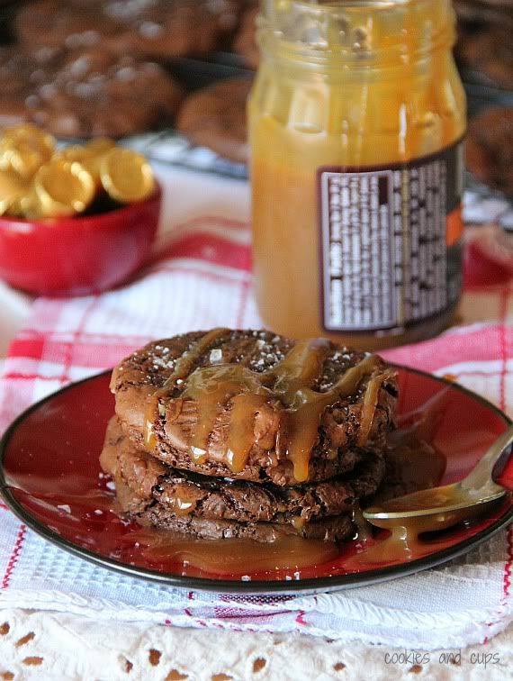 Salted Caramel Rolo Brownie Cookies stacked on a plate with caramel drizzle