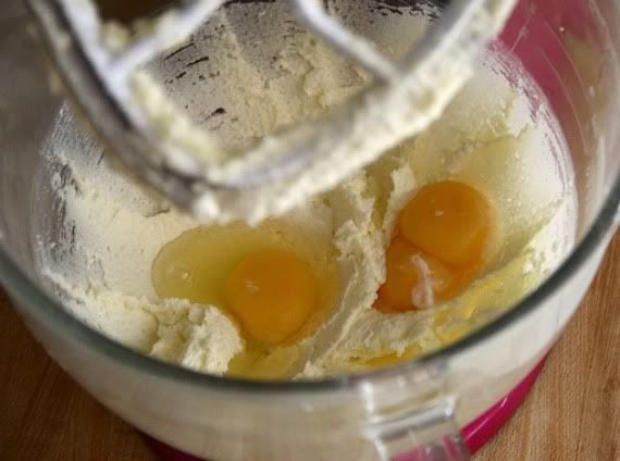 Eggs added to lemon brownie batter in a stand mixer bowl.