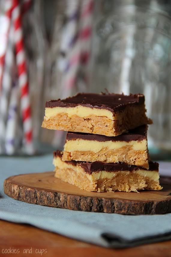 A stack of peanut butter crunch eclair bars on a wooden board