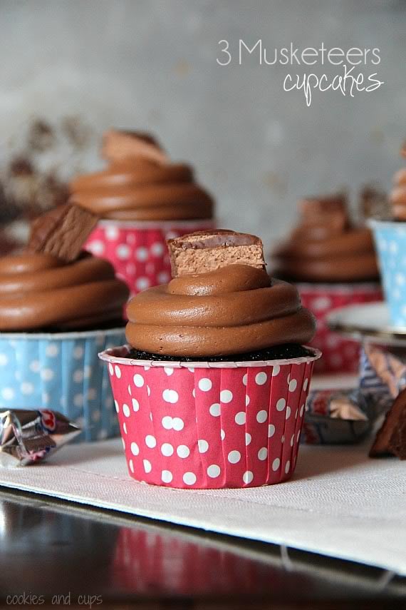 Side view of 3 musketeers cupcakes with red and blue wrappers