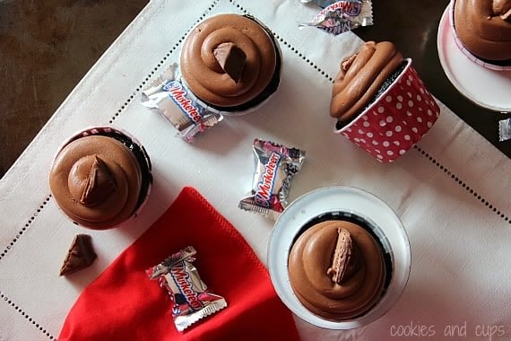 Top view of chocolate-frosted cupcakes with mini 3 Musketeers candy bars
