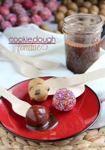 Cookie dough balls on a plate with a jar of chocolate sauce