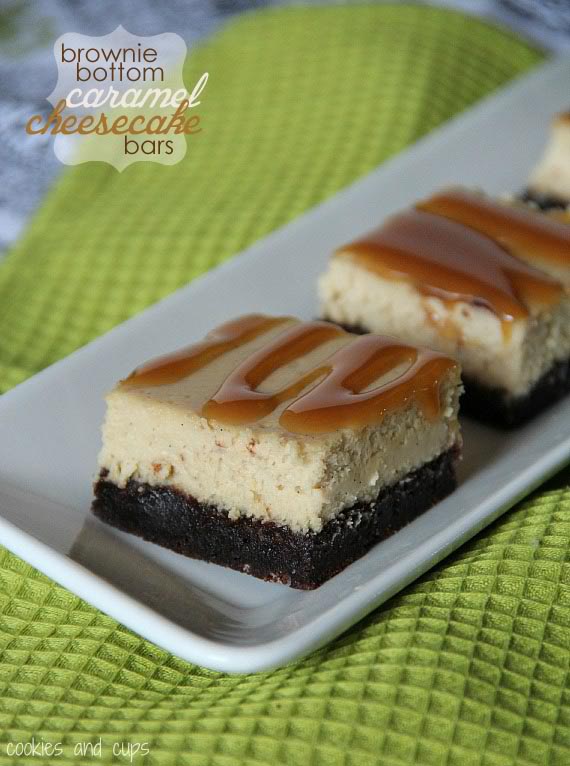 Close-up of brownie-bottom cheesecake bars with caramel drizzle on a platter