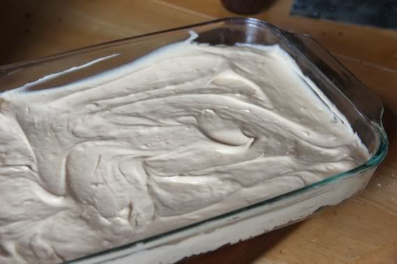 Peanut butter cream cheese frosting layer spread in a 9x13 pan