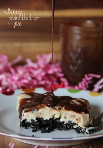 Side view of a serving of Sloppy Peanut Butter Pie on a plate with chocolate being drizzled on top